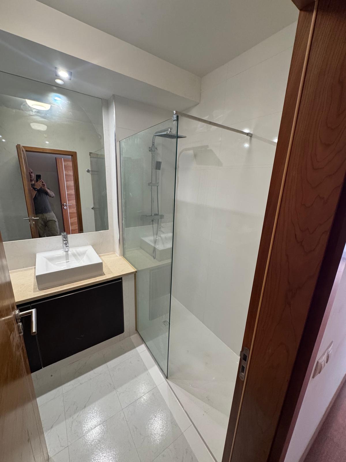 Bathroom after renovation with new glass shower enclosure